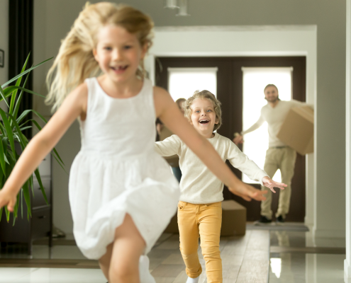 Two Children Running into New House Followed by Parents | 3GuysMoving.com