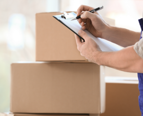 Professional Packer with Clipboard and Moving Boxes | 3GuysMoving.com