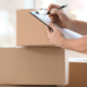 Professional Packer with Clipboard and Moving Boxes | 3GuysMoving.com