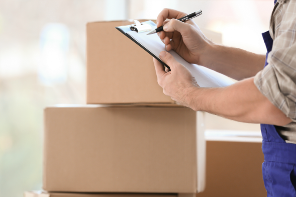 Professional Packer with Clipboard and Moving Boxes | 3GuysMoving.com